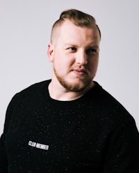 a man with a beard wearing a black sweatshirt